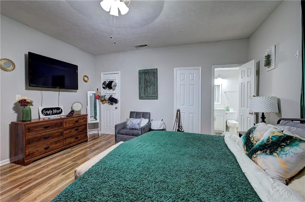 413 Calhoun Avenue Northeast Rome, GA 30161 - Photo 23 of 27 a bed room with furniture and a flat screen tv