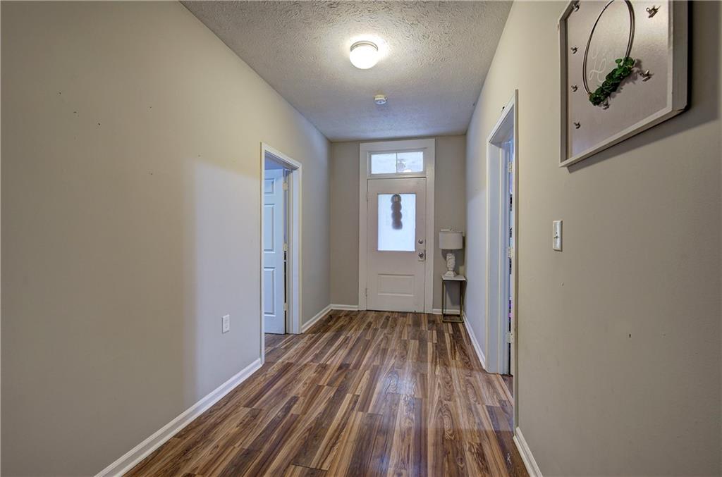 413 Calhoun Avenue Northeast Rome, GA 30161 - Photo 5 of 27 a view of a room with wooden floor mirror and window