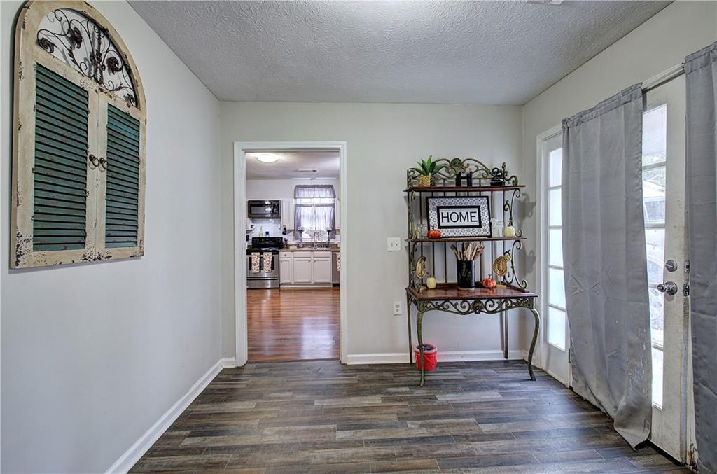 413 Calhoun Avenue Northeast Rome, GA 30161 - Photo 7 of 27 a view of a livingroom with wooden floor and kitchen