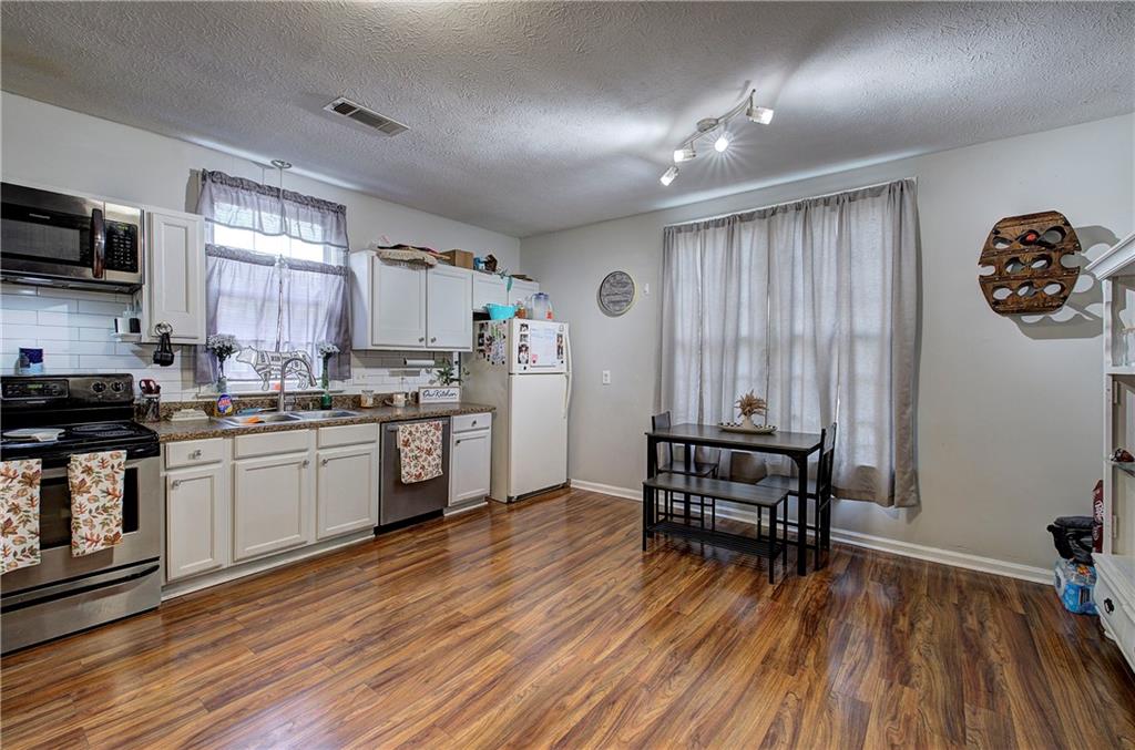 413 Calhoun Avenue Northeast Rome, GA 30161 - Photo 9 of 27 a kitchen with a refrigerator and a stove top oven