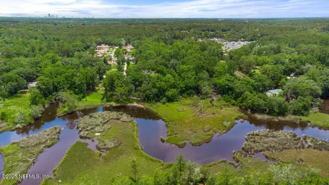 an aerial view of a house with a yard