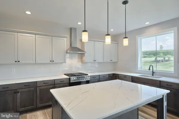 a kitchen with a table chairs and white cabinets