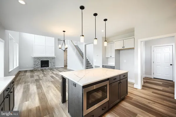 a kitchen with a stove sink and a wooden floor