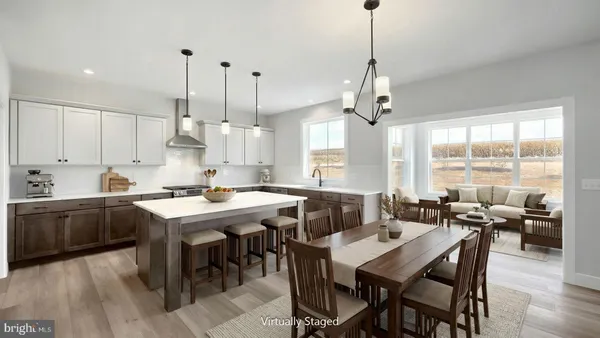 a view of a dining room and livingroom with furniture wooden floor a chandelier
