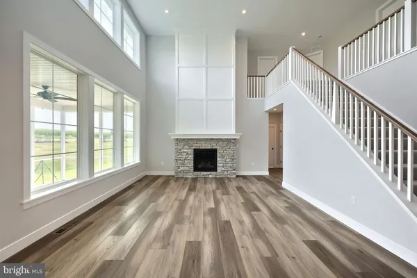 a view of empty room with wooden floor and fireplace