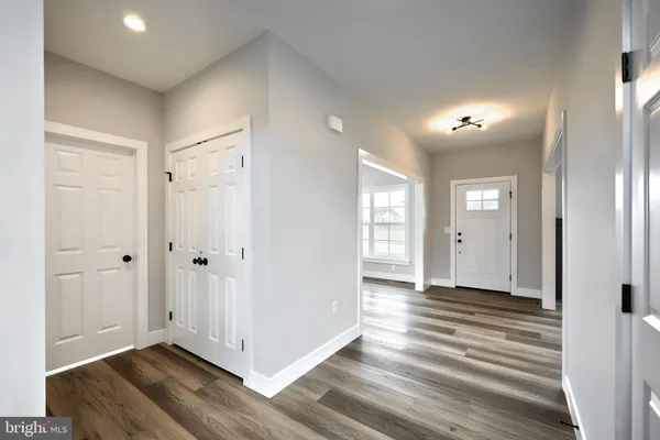 a view of a hallway with wooden floor