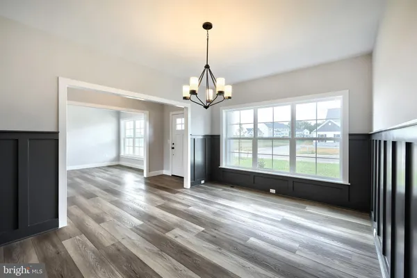 a view of a room with window wooden floor and chandelier