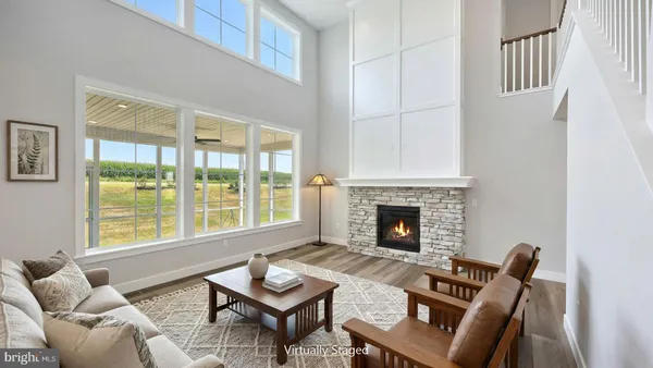 a living room with furniture a fireplace and a table