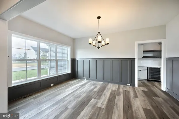 a view of a room with a ceiling fan and window