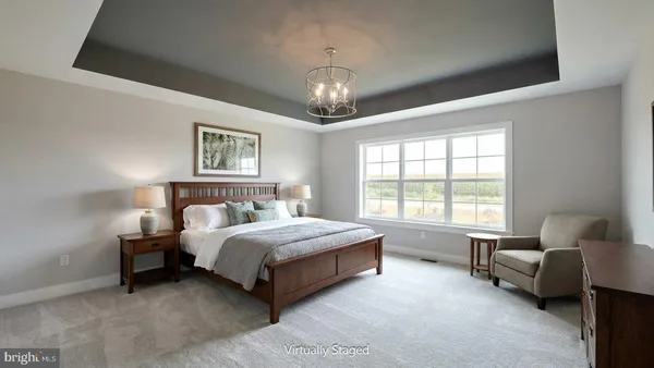 a spacious bedroom with a bed couch and window