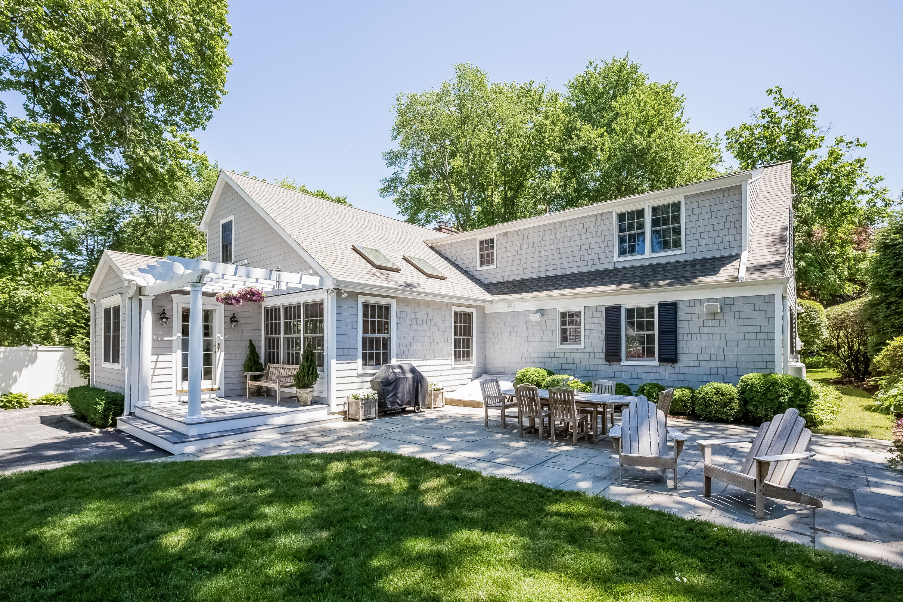 21 Sunset Road Darien, CT 06820 - Photo 22 of 29 a view of a patio with table and chairs potted plants and large tree