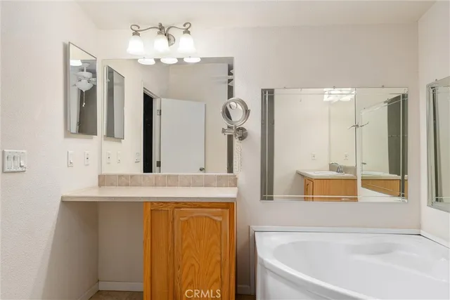 a bathroom with a tub sink and mirror