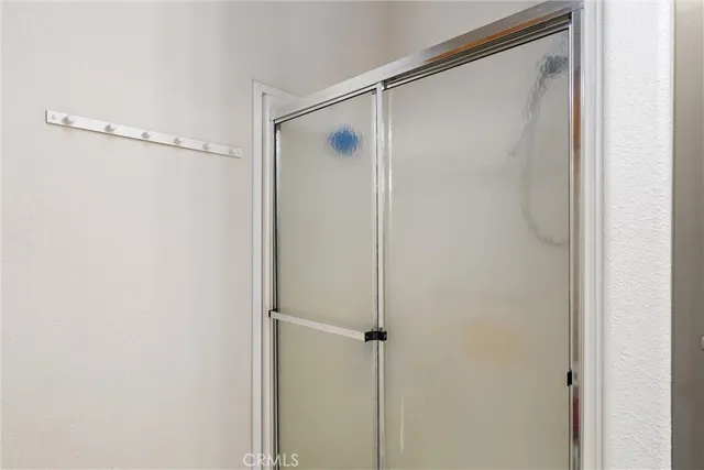 a bathroom with a glass shower door