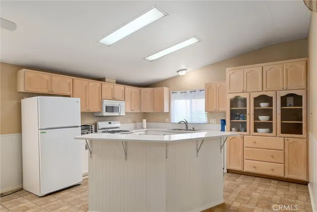 a kitchen with stainless steel appliances granite countertop a refrigerator sink and cabinets