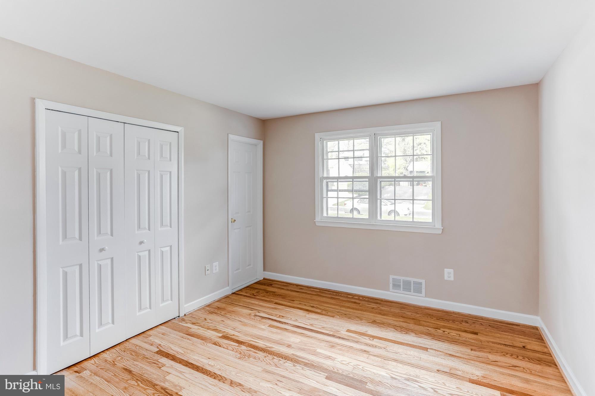 1321 Gresham Road Silver Spring, MD 20904 - Photo 17 of 30 an empty room with wooden floor closet and windows
