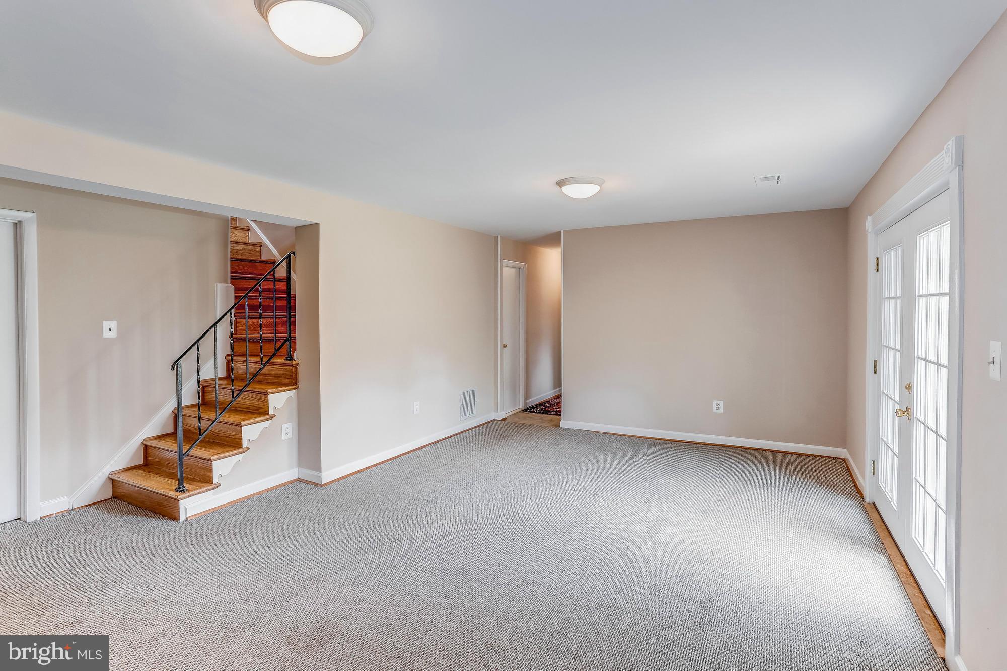 1321 Gresham Road Silver Spring, MD 20904 - Photo 21 of 30 an empty room with staircase and white walls
