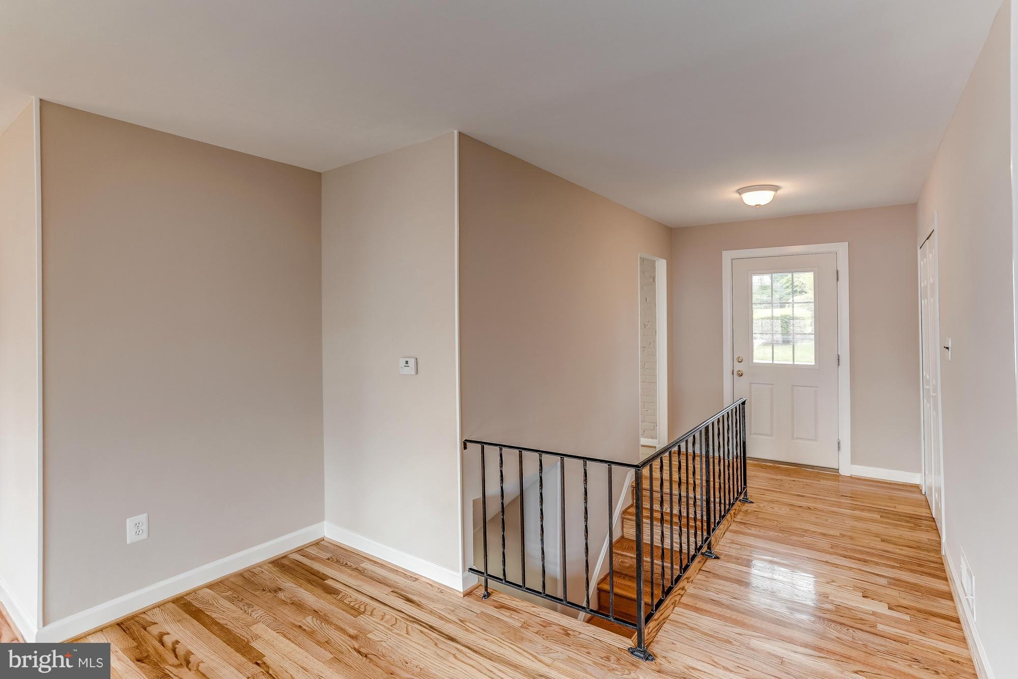 1321 Gresham Road Silver Spring, MD 20904 - Photo 4 of 30 a view of a hallway with wooden floor and windows
