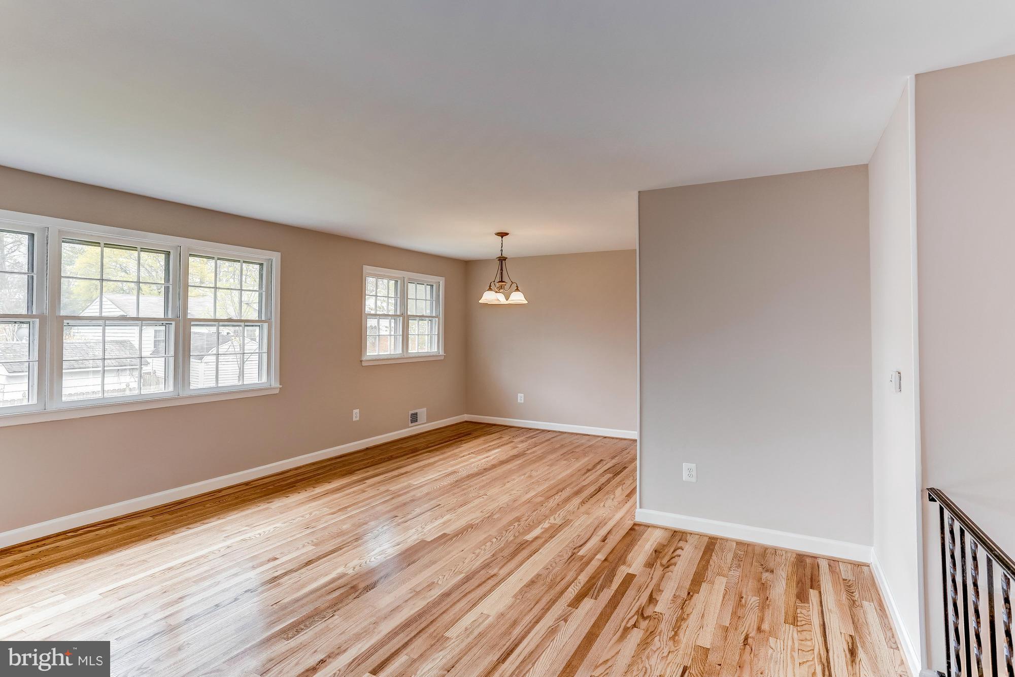 1321 Gresham Road Silver Spring, MD 20904 - Photo 5 of 30 a view of an empty room with wooden floor and a window