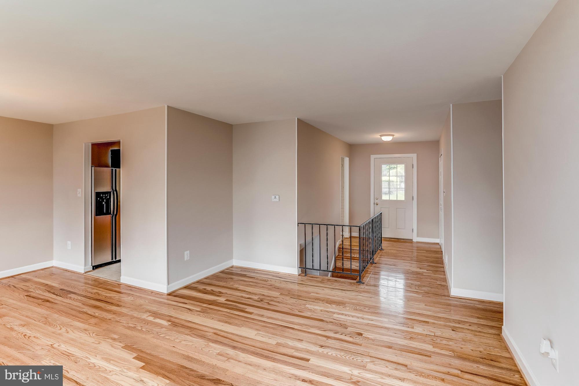 1321 Gresham Road Silver Spring, MD 20904 - Photo 6 of 30 a view of a room with wooden floor and stairs