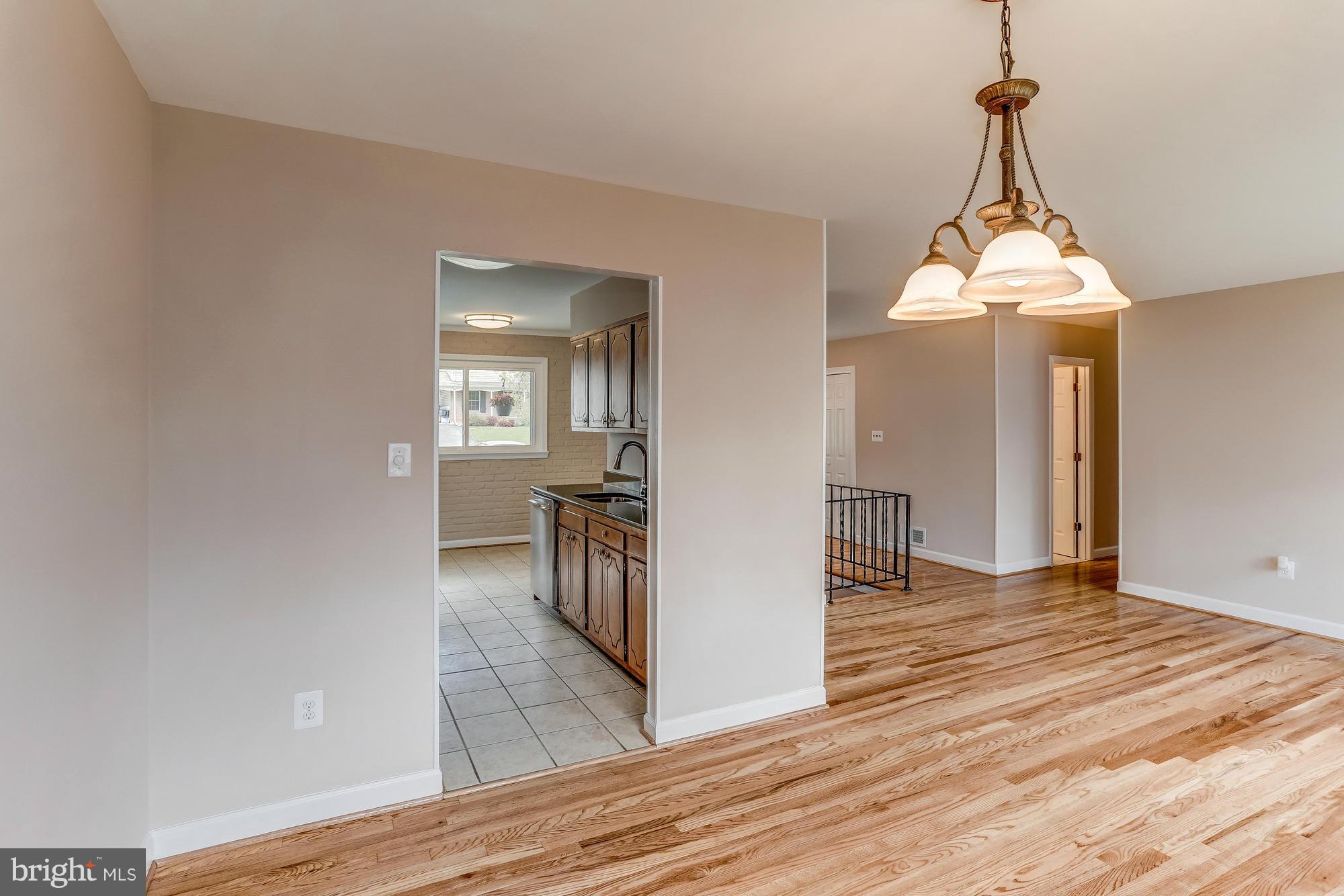 1321 Gresham Road Silver Spring, MD 20904 - Photo 8 of 30 a view of a room with wooden floor and staircase