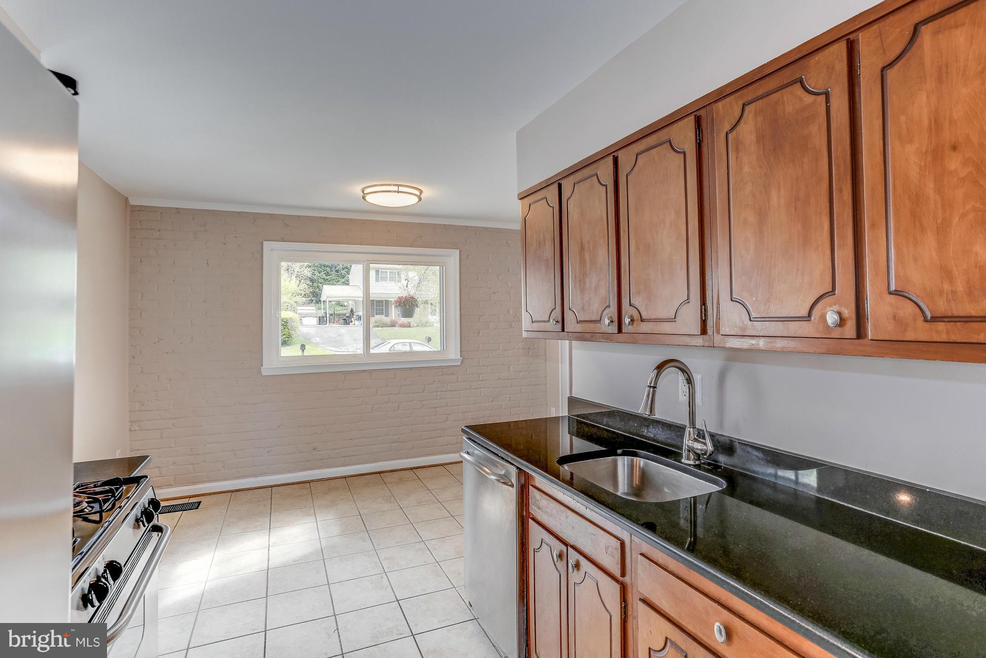 1321 Gresham Road Silver Spring, MD 20904 - Photo 10 of 30 a kitchen with a sink cabinets and window