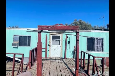 a view of a house with a porch and furniture