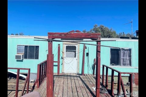 a view of a house with a porch and furniture