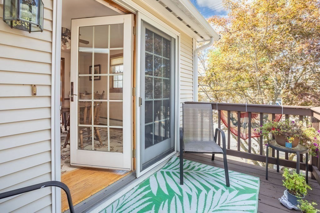 4 Clement Avenue Peabody, MA 01960 - Photo 12 of 25 a view of a balcony with wooden floor and iron fence