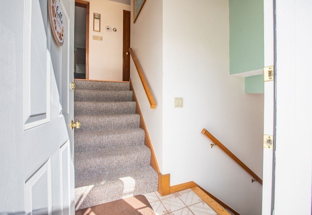 4 Clement Avenue Peabody, MA 01960 - Photo 20 of 25 a view of staircase with lots of frames on wall and windows