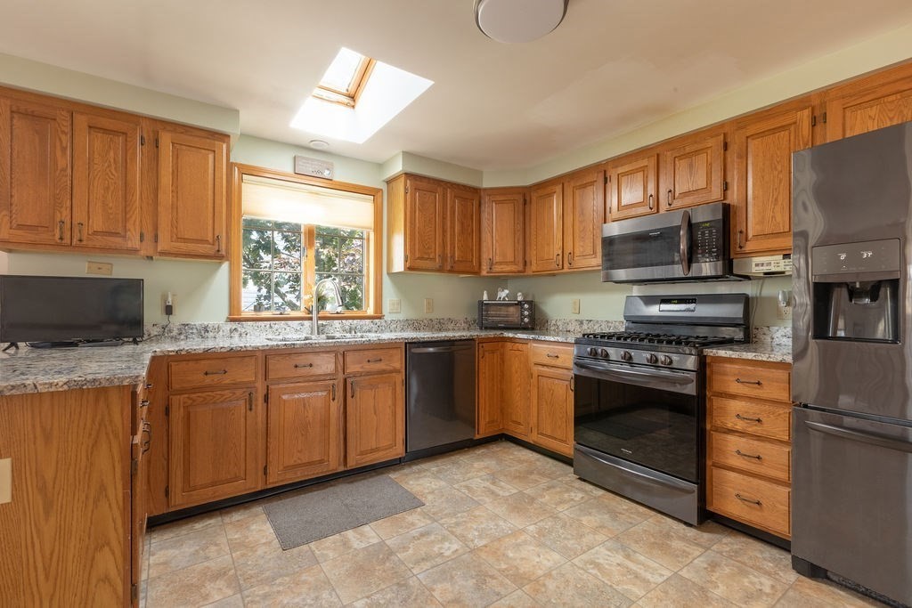 4 Clement Avenue Peabody, MA 01960 - Photo 7 of 25 a kitchen with stainless steel appliances granite countertop a stove top oven a sink dishwasher and a refrigerator