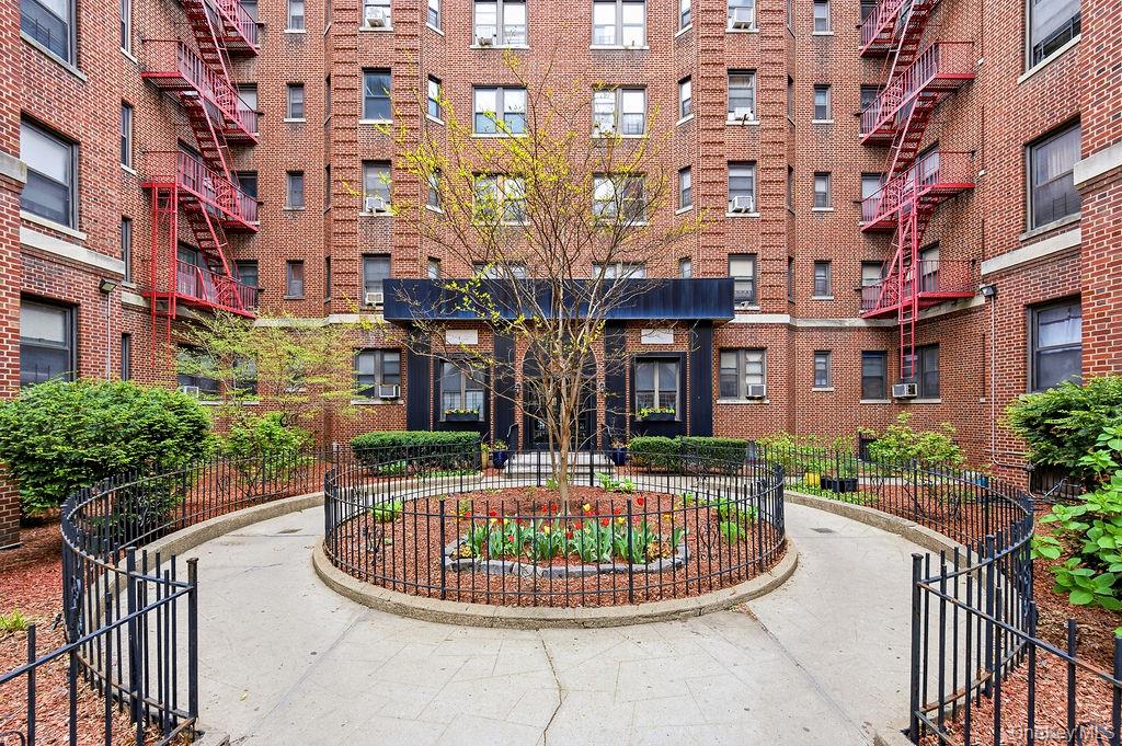 155-01 90th, Unit 3R Queens, NY 11432 - Photo 15 of 16 a front view of a multi story building with yard