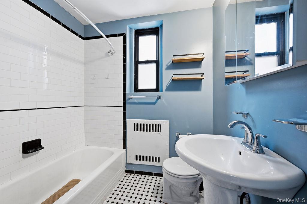 155-01 90th, Unit 3R Queens, NY 11432 - Photo 9 of 16 a bathroom with a sink a toilet and shower