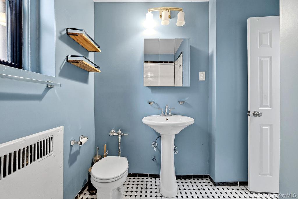 155-01 90th, Unit 3R Queens, NY 11432 - Photo 10 of 16 a bathroom with a sink toilet and a mirror