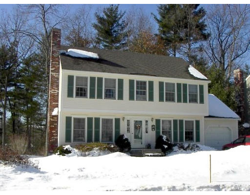 a view of a house with a yard covered in snow