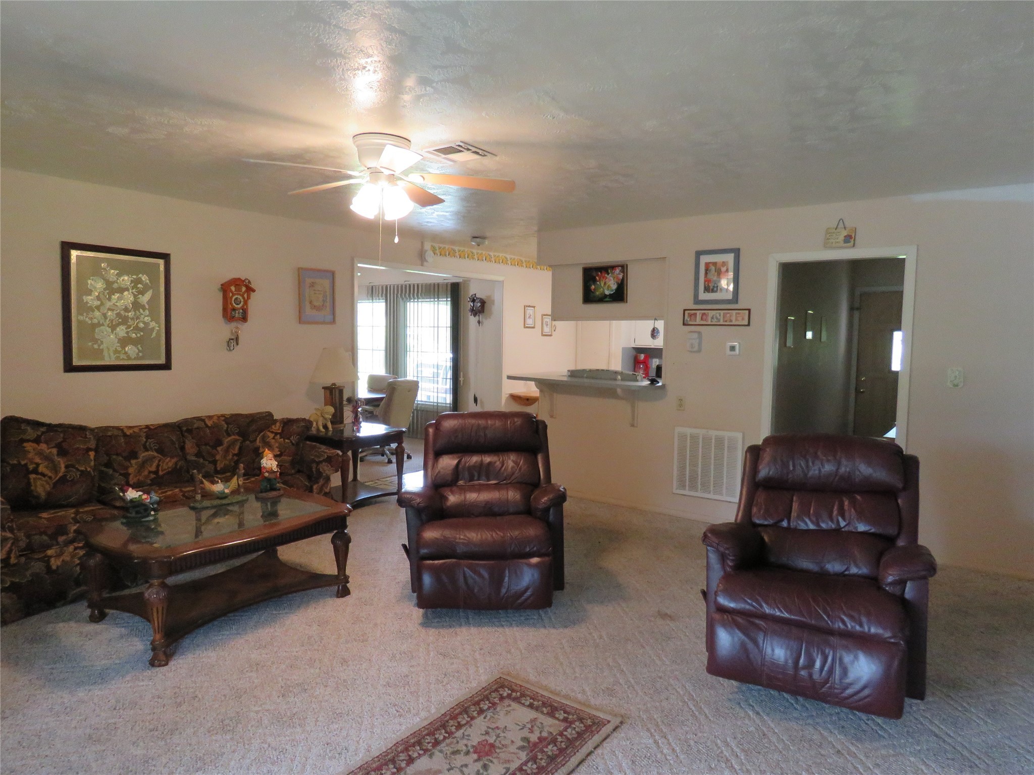 15255 Austin Road Willis, TX 77378 - Photo 11 of 25 a living room with furniture and a ceiling fan
