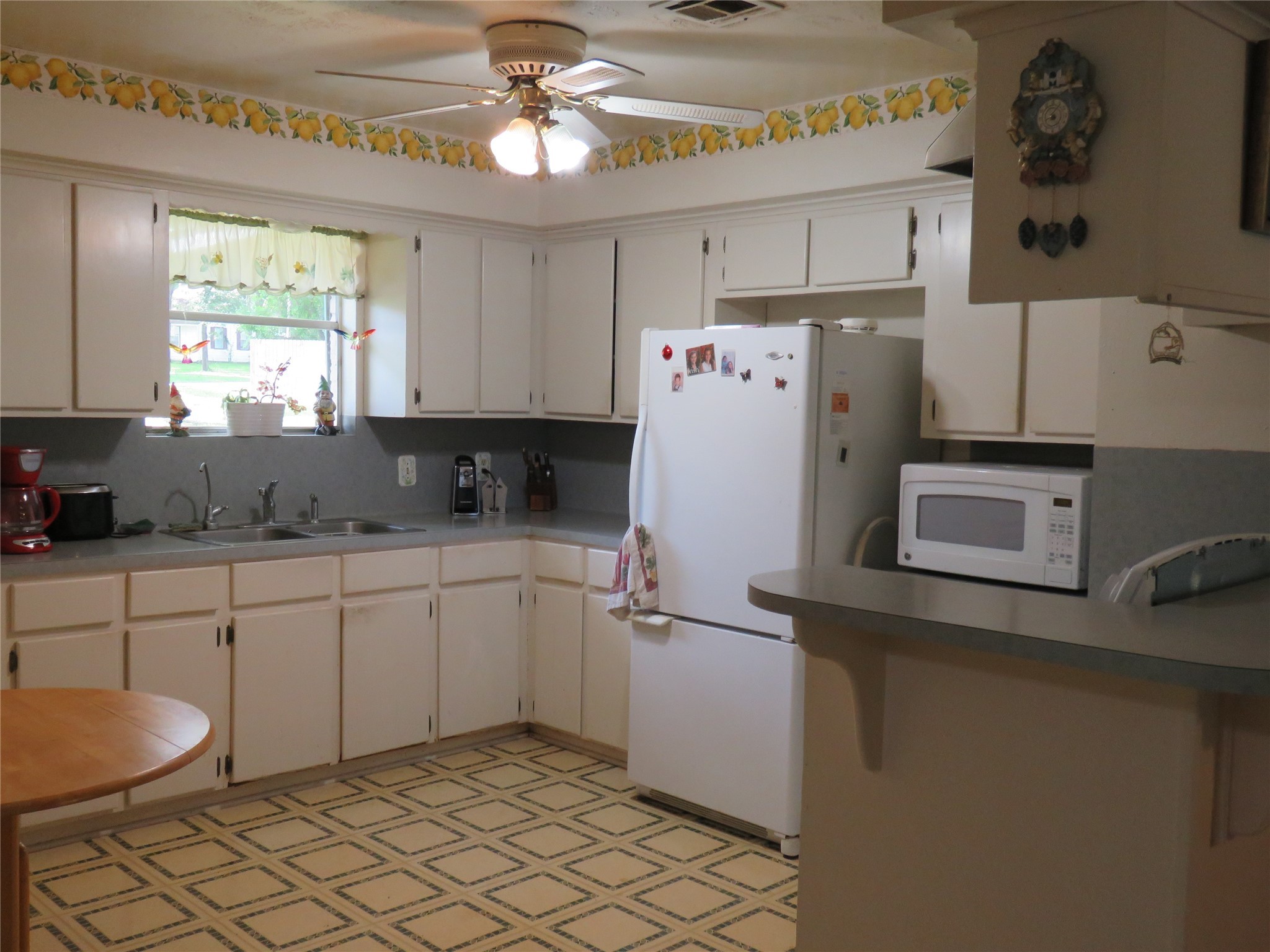15255 Austin Road Willis, TX 77378 - Photo 12 of 25 a kitchen with a refrigerator a sink and cabinets