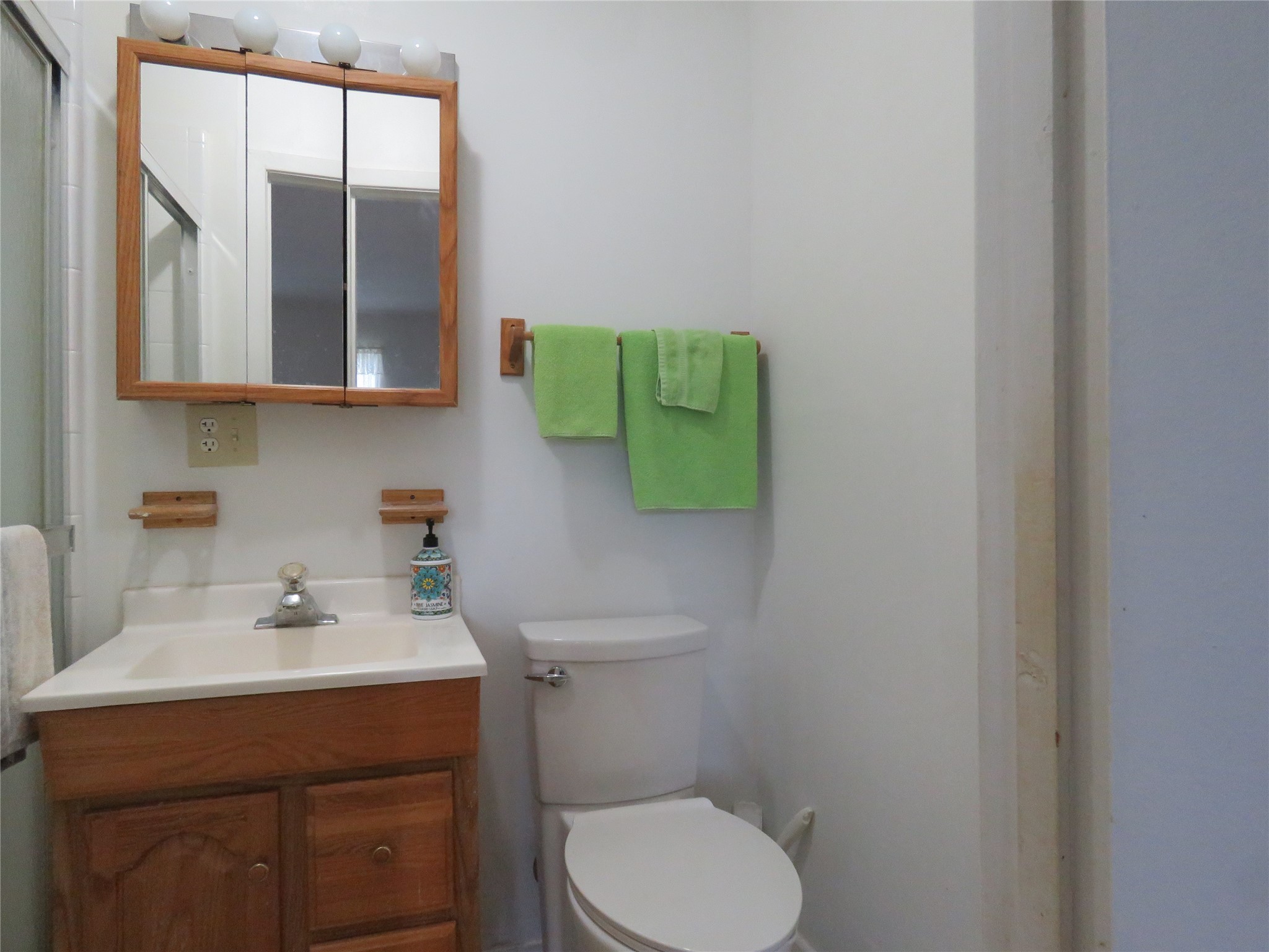 15255 Austin Road Willis, TX 77378 - Photo 17 of 25 a bathroom with a toilet sink and mirror