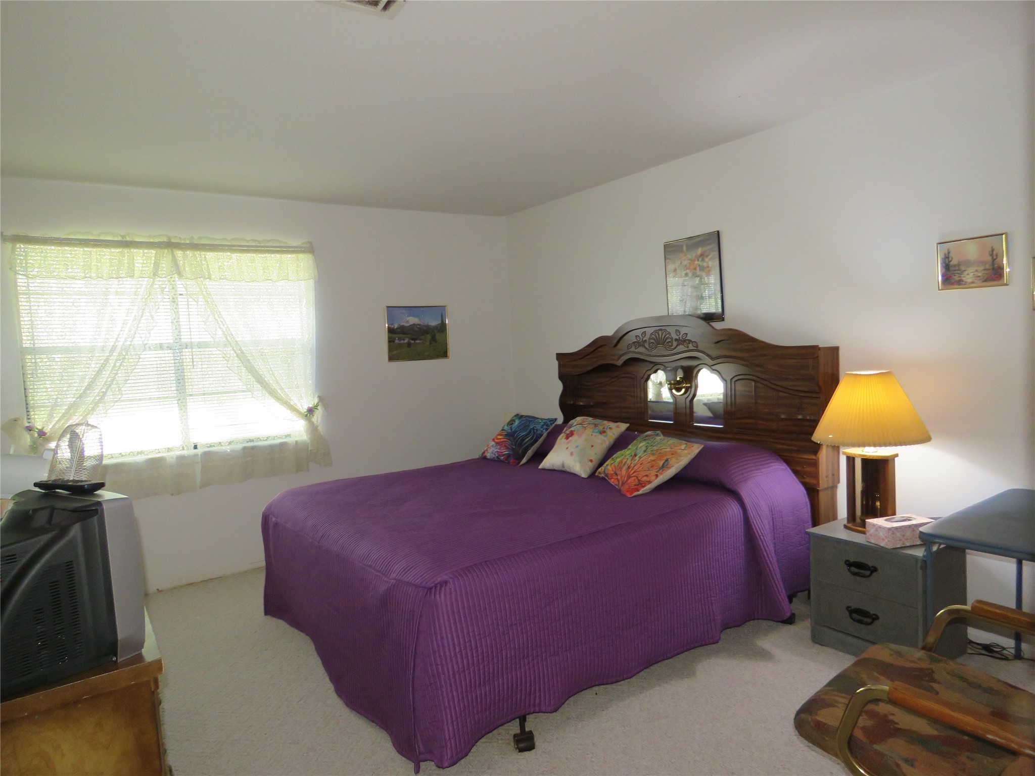 15255 Austin Road Willis, TX 77378 - Photo 18 of 25 a bedroom with a bed and a lamp