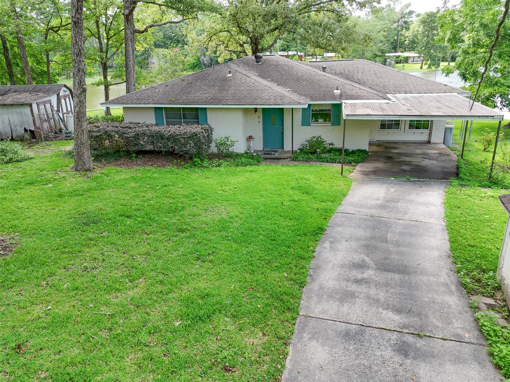 15255 Austin Road Willis, TX 77378 - Photo 2 of 25 a front view of a house with a garden and trees