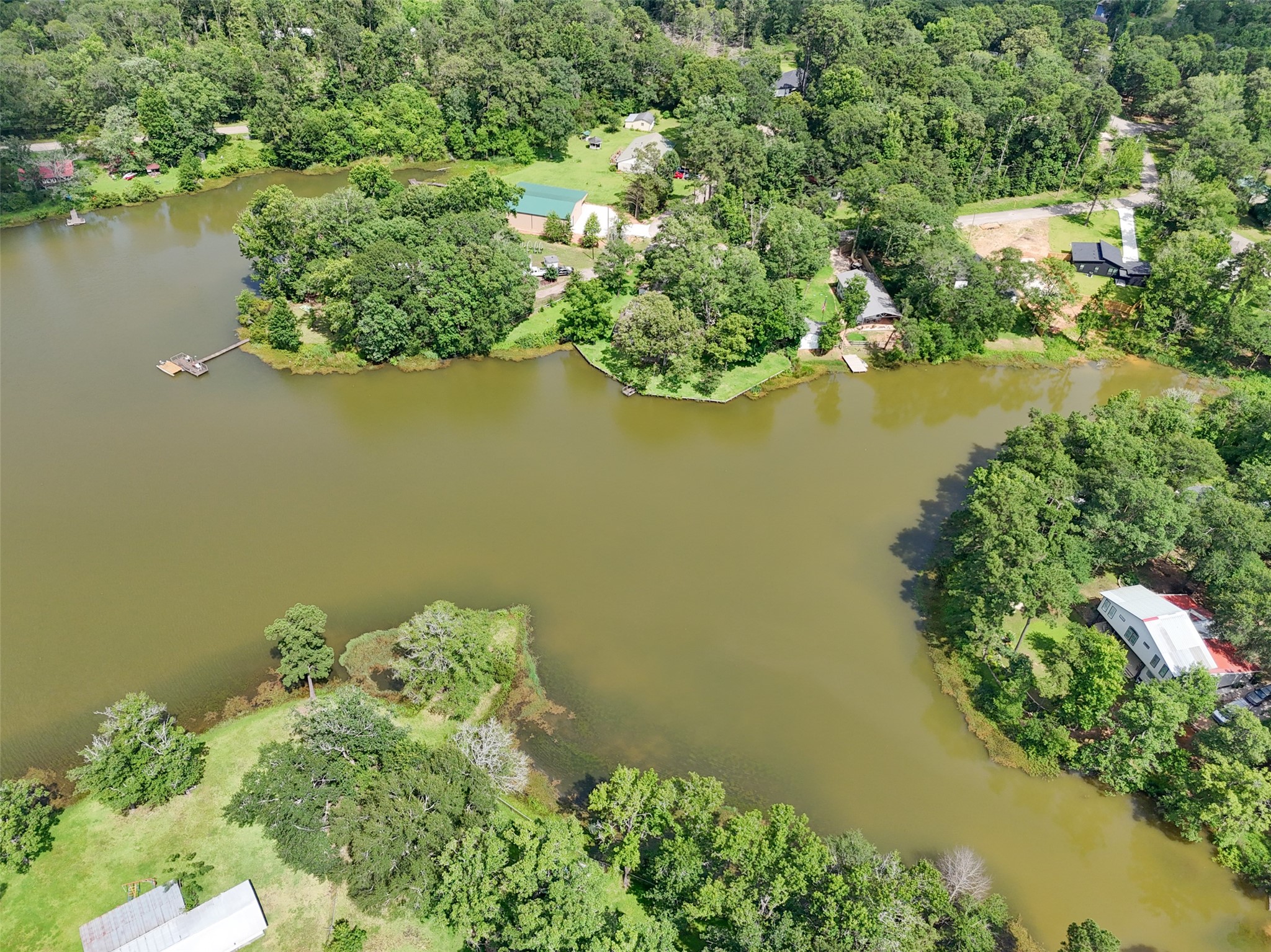 15255 Austin Road Willis, TX 77378 - Photo 22 of 25 an aerial view of a houses with a lake view