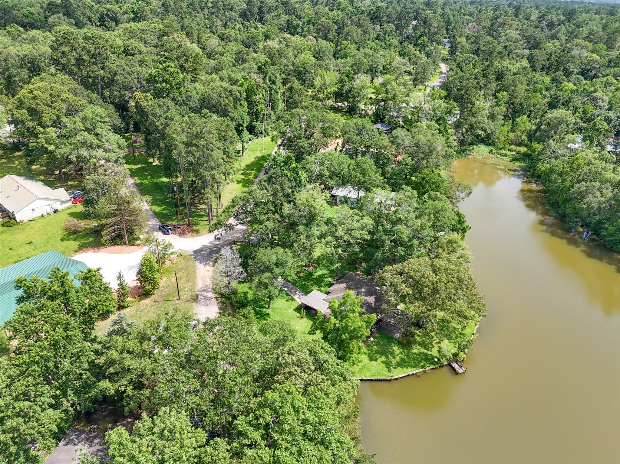 15255 Austin Road Willis, TX 77378 - Photo 24 of 25 a view of a lake with a house