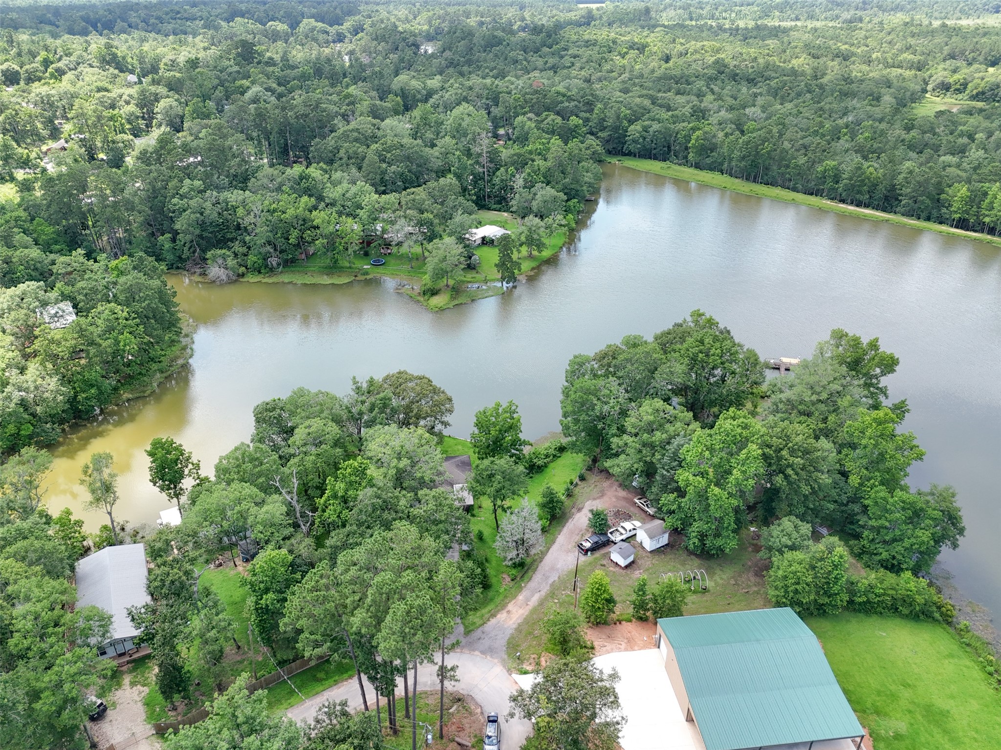 15255 Austin Road Willis, TX 77378 - Photo 6 of 25 an aerial view of a house with a yard and lake view