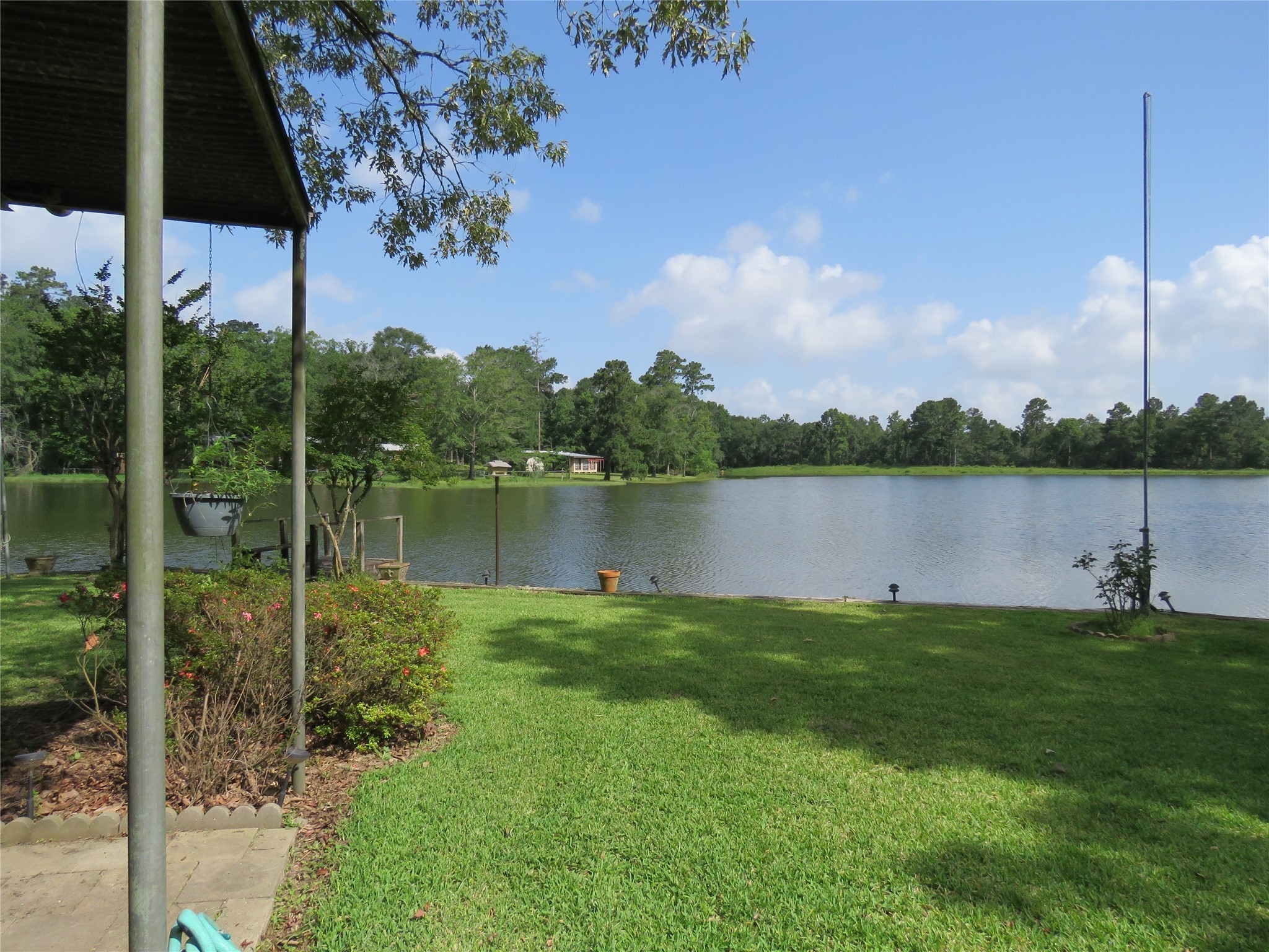 15255 Austin Road Willis, TX 77378 - Photo 8 of 25 a view of a lake with a house in the background