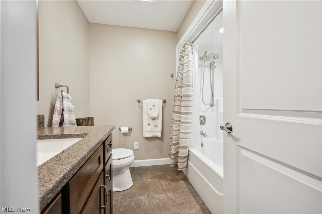 14001 Mason Road Vermilion, OH 44089 - Photo 11 of 22 Full bathroom with vanity, shower / tub combo with curtain, toilet, and tile patterned floors