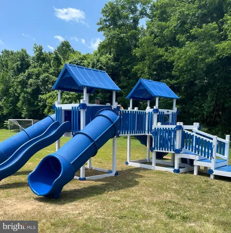 a view of backyard with swimming pool and porch