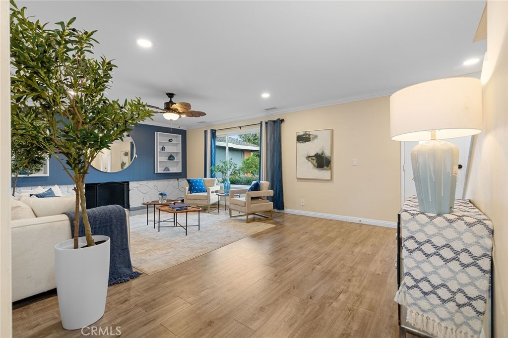 2914 South Rene Drive Santa Ana, CA 92704 - Photo 11 of 38 a living room with furniture a window and a table with wooden floor
