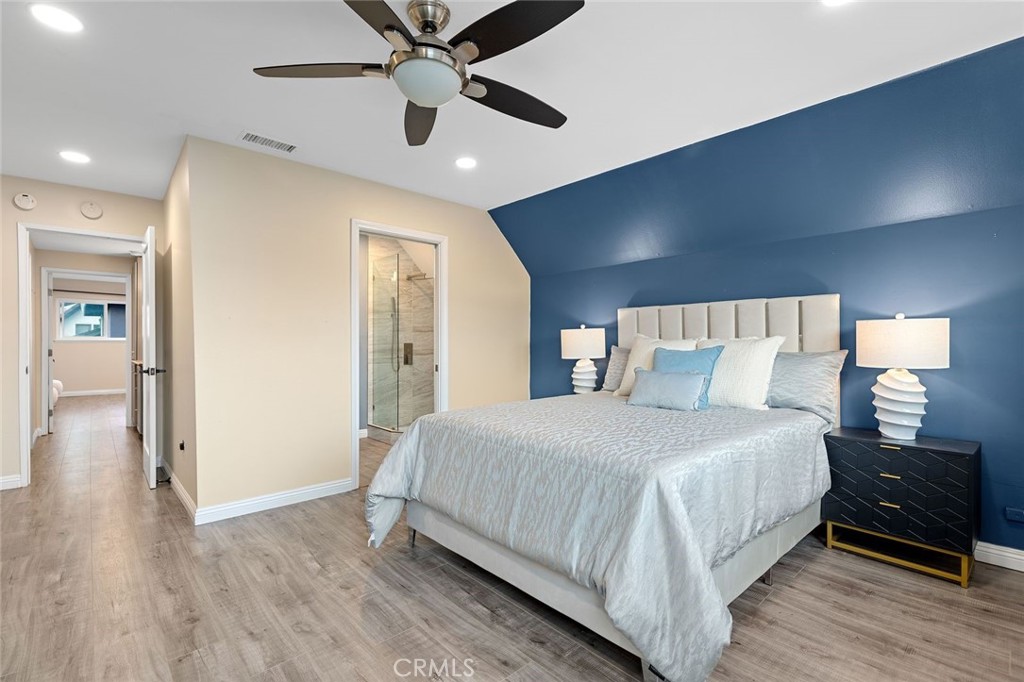 2914 South Rene Drive Santa Ana, CA 92704 - Photo 33 of 38 a bedroom with a bed and wooden floor