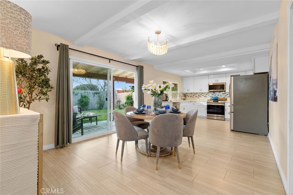 2914 South Rene Drive Santa Ana, CA 92704 - Photo 8 of 38 a dining room with furniture a chandelier and wooden floor