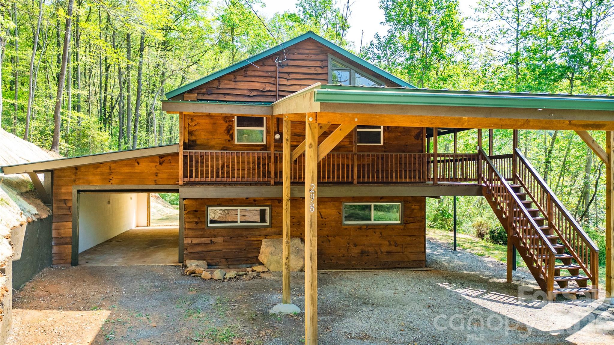 298 Timbuktu Road Sylva, NC 28779 - Photo 17 of 24 a view of a house with a yard