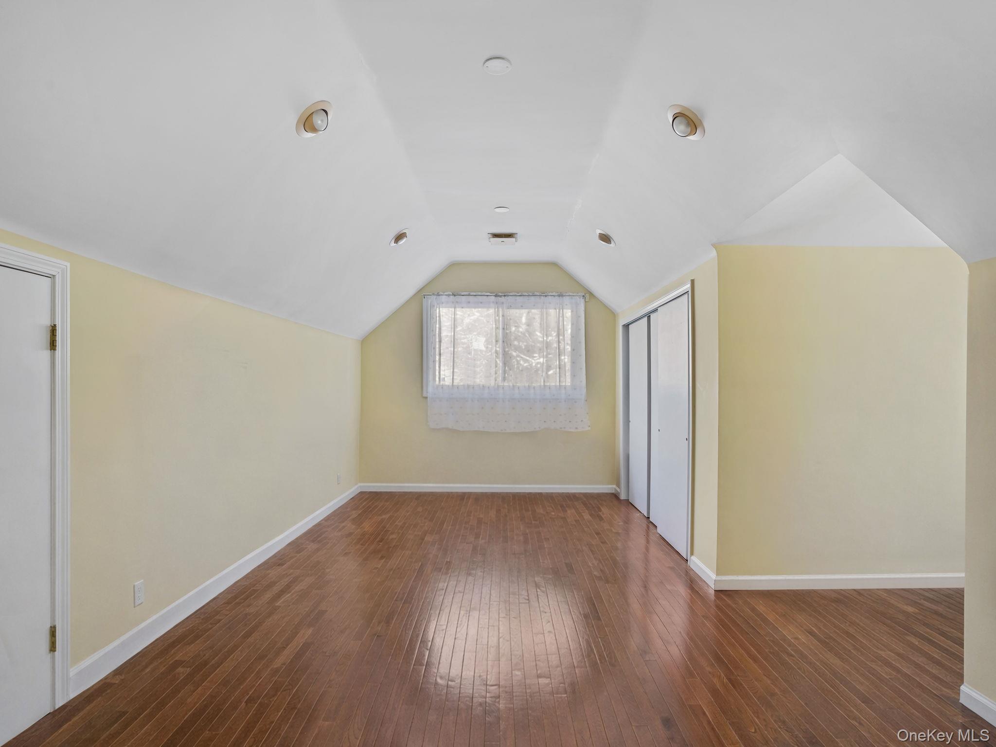 1 Village Lane Bronxville, NY 10708 - Photo 12 of 16 an empty room with wooden floor and windows